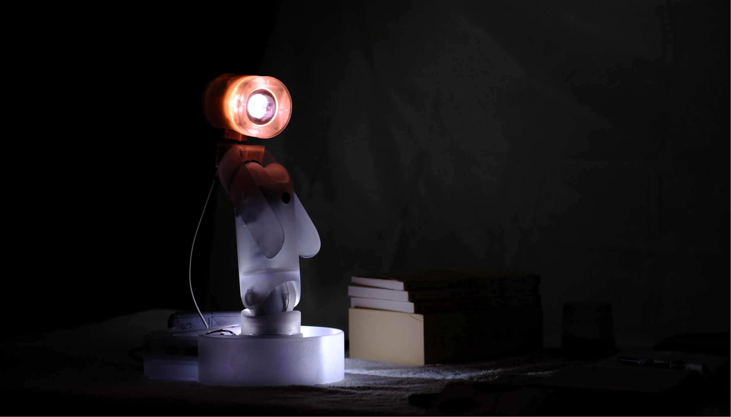 Lighbo illuminated on a dark desk