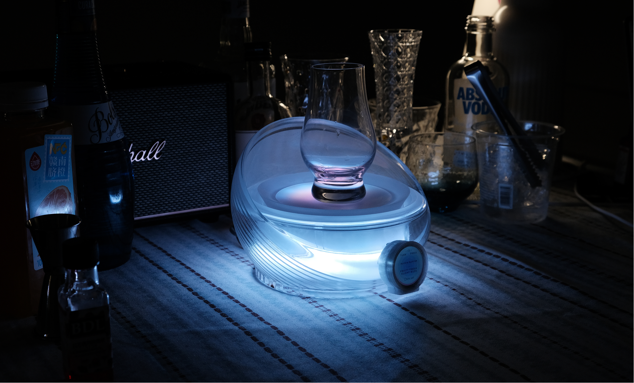 Poursona device in a low-light home bar scene