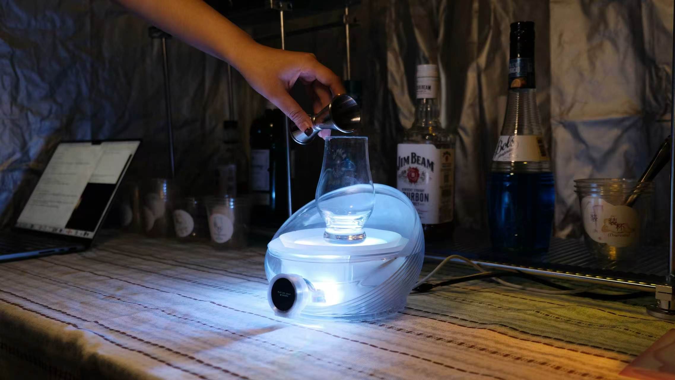 Poursona being used while pouring a drink
